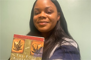 Sharnise Dozier, MS with book "The Four Agreements"